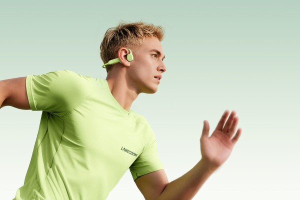 Athlete wearing Langsdom headphones in motion