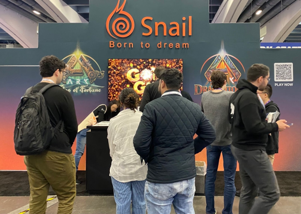 Snail Games booth at GDC 2026, with attendees gathered around displays for ARK: Tides of Fortune and ARK: Dragontopia