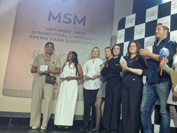 A group of people standing on a stage

Description automatically generated