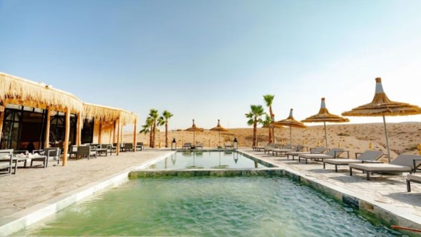 Agafay Desert camp with swimming pool and shaded lounge area near Marrakech, ideal for families