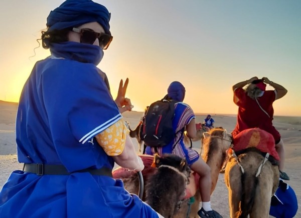 Tourists riding camels through the Agafay Desert near Marrakech