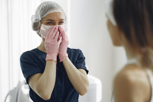 Free Woman in Blue Scrub Suit Feeling Happy Stock Photo