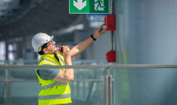 A person in a safety vest and helmet

Description automatically generated